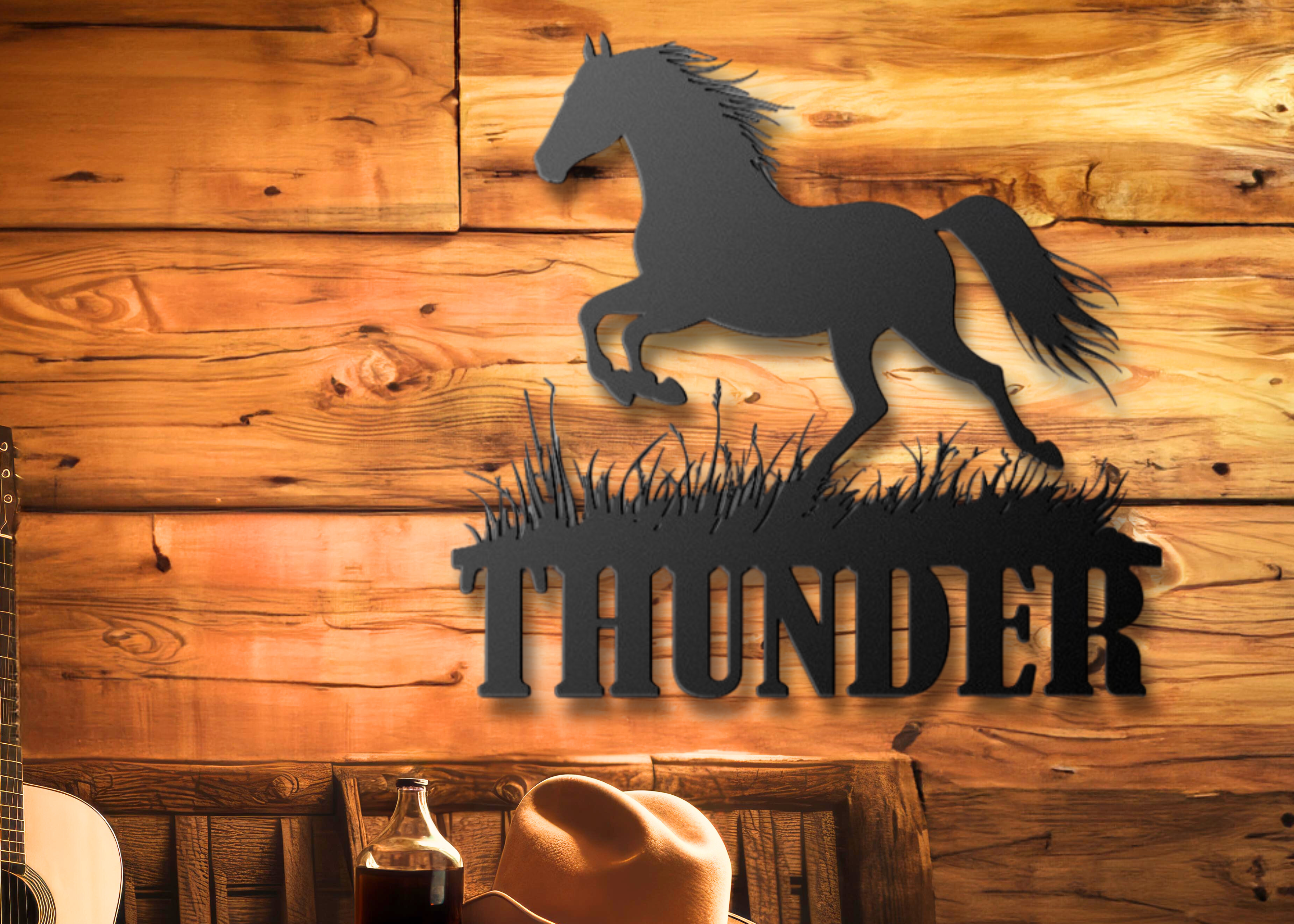Custom metal horse name sign – “Thunder” design by Hoofbeat Equestrian Décor. Personalized wall art for barns, ranches, or homes. Decorative metal sign with horse silhouette and 'THUNDER' text on a wooden wall, with a guitar and cowboy hat on a table in the foreground.